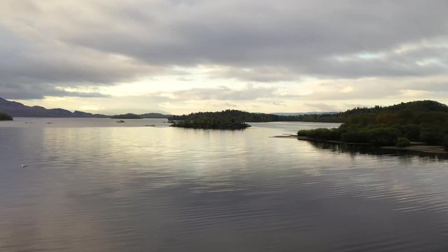 Aerial depiction of beautiful Loch Lomond at sunrise, featuring Fraoch Eilean and Eilean Daraich islets, Scottish Highlands, Scotland