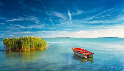 Lake Balaton with a red boat on a sunny day