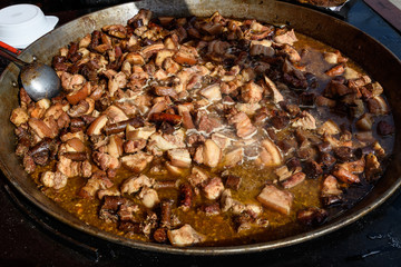 Deep fried meat being cooked at a street food festival