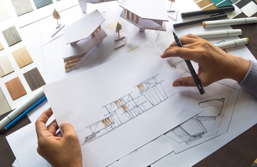 architect design working drawing sketch plans blueprints and making architectural construction model in architect studio