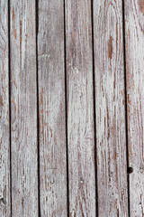 Fototapeta premium A whitewashed wooden surface worn out due to weather. Planks painted white. The texture of the wooden board.