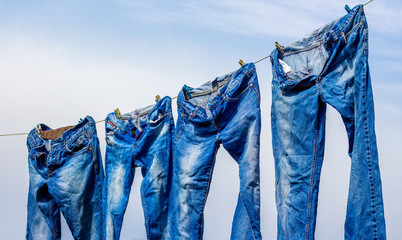 Jeans dry after washing, hung on the rope_