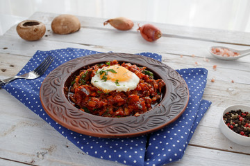 Baked vegetables with tomato sauce and egg