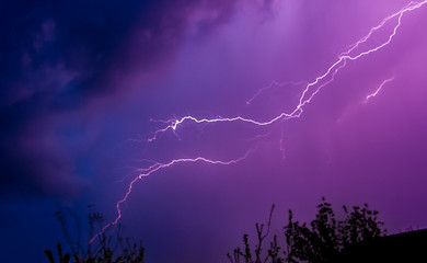 Lightning in the dark sky at night during a thunderstorm_