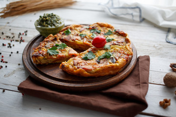 homemade egg and vegetable pie with sauce pesto