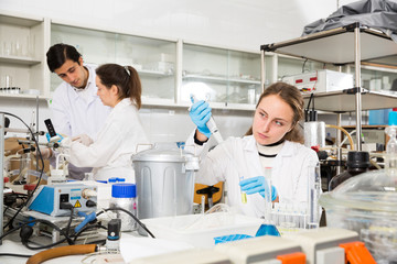 Female pipetting reagent in test tube