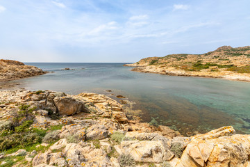 jagged red rocks on the coast of the Desert des Agriates at Ostriconi in the Balagne region of Corsica, France
