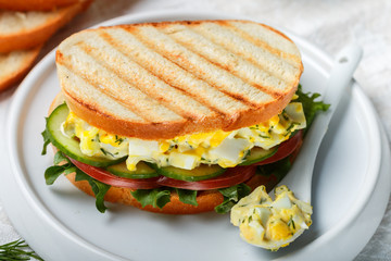 Sandwich with egg salad, lettuce, tomatoes, cucumbers and dill. Gourmet Breakfast. Selective focus