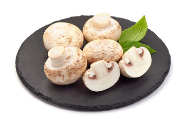 Fresh champignon mushrooms, close-up, isolated on white background