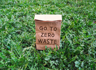 Go to zero waste ecological shopping bag on the green grass. An alternative to disposable packages. Zero waste concept.
