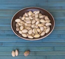 Healthy food  for background image close up pistachios nuts. Texture on top view Nuts pistachio on the cup plate