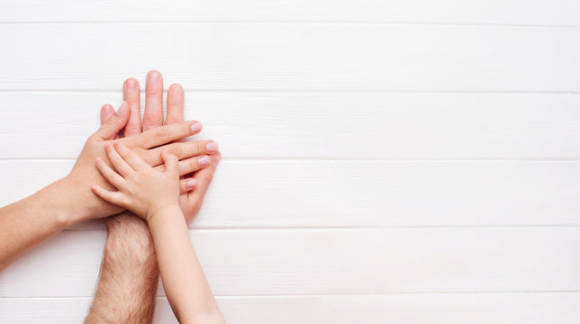 Hands Of Father, Mother And Kid On White Background