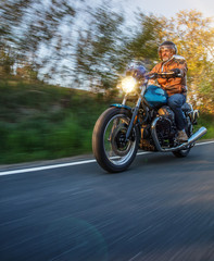 Moto racer riding on mountain road, travel to Europe.