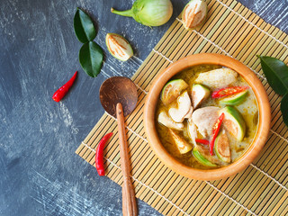 Chicken green curry with eggplant, famous traditional Thai food in top view with copy space.