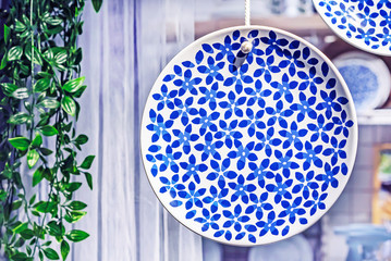 Dish with blue floral ornament in the interior of a modern kitchen.