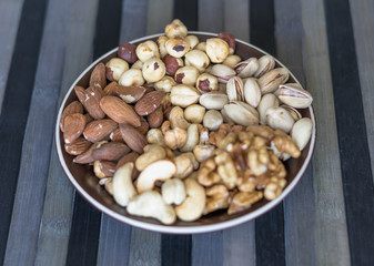 Healthy food. Nuts mix assortment on stone texture top view. Collection of different legumes for background image close up nuts, pistachios, almond, cashew nuts, peanut, walnut. image