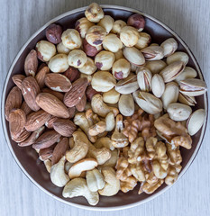 Healthy food. Nuts mix assortment on white grey table top view. Collection of different legumes for background image close up nuts, pistachios, almond, cashew nuts, peanut, walnut. image
