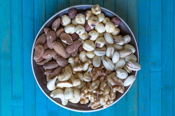Healthy food. Nuts mix assortment on stone texture top view. Collection of different legumes for background image close up nuts, pistachios, almond, cashew nuts, peanut, walnut. image
