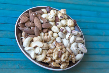 Healthy food. Nuts mix assortment on stone texture top view. Collection of different legumes for background image close up nuts, pistachios, almond, cashew nuts, peanut, walnut. image
