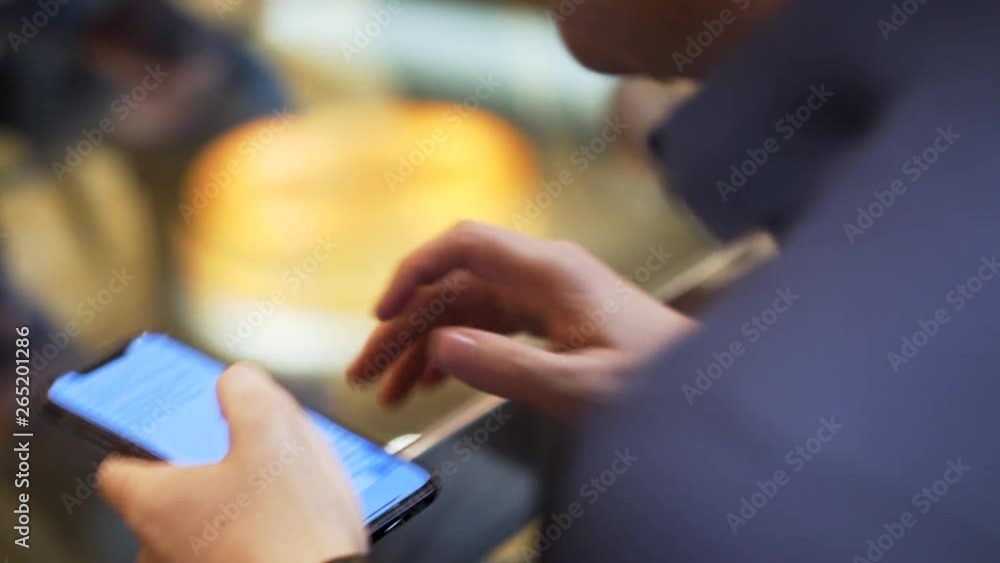 Poster close up of a man holding device and reading the text on the screen, modern technologies concept. st