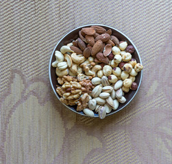 Healthy food. Nuts mix assortment on stone texture top view. Collection of different legumes for background image close up nuts, pistachios, almond, cashew nuts, peanut, walnut. image