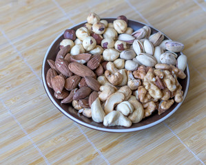 Healthy food. Nuts mix assortment on stone texture top view. Collection of different legumes for background image close up nuts, pistachios, almond, cashew nuts, peanut, walnut. image