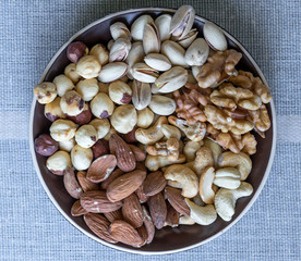 Healthy food. Nuts mix assortment on stone texture top view. Collection of different legumes for background image close up nuts, pistachios, almond, cashew nuts, peanut, walnut. image