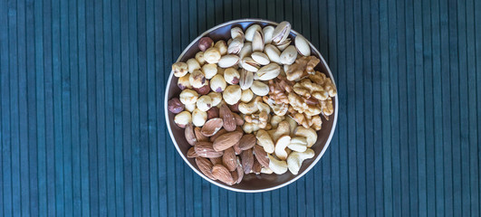 Healthy food. Nuts mix assortment on stone texture top view. Collection of different legumes for background image close up nuts, pistachios, almond, cashew nuts, peanut, walnut. image