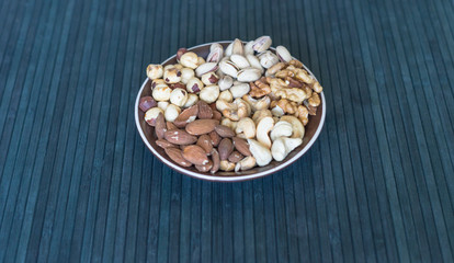 Healthy food. Nuts mix assortment on stone texture top view. Collection of different legumes for background image close up nuts, pistachios, almond, cashew nuts, peanut, walnut. image