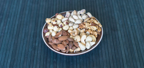 Healthy food. Nuts mix assortment on stone texture top view. Collection of different legumes for background image close up nuts, pistachios, almond, cashew nuts, peanut, walnut. image