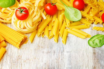 different pasta with tomatoes and spinach leaves