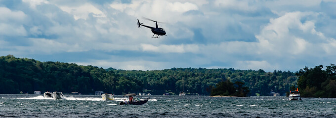 Panorama view of a Helicopter flying over boats on the St. Lawrence River