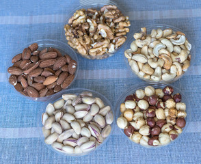 Healthy food. Nuts mix assortment on stone texture top view. Collection of different legumes for background image close up nuts, pistachios, almond, cashew nuts, peanut, walnut. image