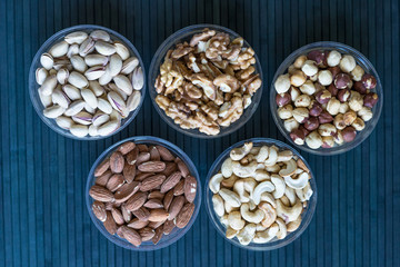 Healthy food. Nuts mix assortment on stone texture top view. Collection of different legumes for background image close up nuts, pistachios, almond, cashew nuts, peanut, walnut. image
