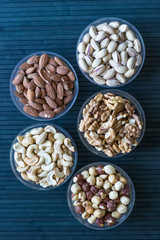 Healthy food. Nuts mix assortment on stone texture top view. Collection of different legumes for background image close up nuts, pistachios, almond, cashew nuts, peanut, walnut. image