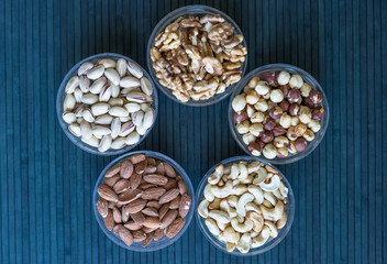 Healthy food. Nuts mix assortment on stone texture top view. Collection of different legumes for background image close up nuts, pistachios, almond, cashew nuts, peanut, walnut. image