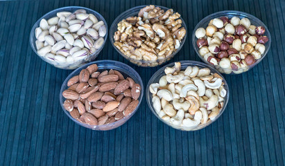 Healthy food. Nuts mix assortment on stone texture top view. Collection of different legumes for background image close up nuts, pistachios, almond, cashew nuts, peanut, walnut. image