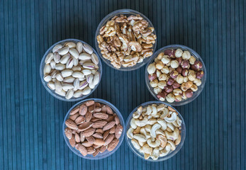 Healthy food. Nuts mix assortment on stone texture top view. Collection of different legumes for background image close up nuts, pistachios, almond, cashew nuts, peanut, walnut. image