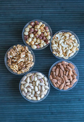 Healthy food. Nuts mix assortment on stone texture top view. Collection of different legumes for background image close up nuts, pistachios, almond, cashew nuts, peanut, walnut. image