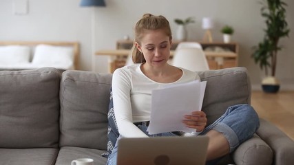 Stressed girl student feeling worried reading bad news in papers