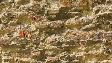 Background of old stone wall. The texture of the stone surface. Brickwork in the old European city. Pattern in retro style