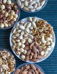 Healthy food. Nuts mix assortment on stone texture top view. Collection of different legumes for background image close up nuts, pistachios, almond, cashew nuts, peanut, walnut. image