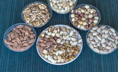 Healthy food. Nuts mix assortment on stone texture top view. Collection of different legumes for background image close up nuts, pistachios, almond, cashew nuts, peanut, walnut. image