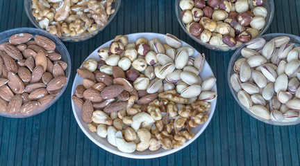 Healthy food. Nuts mix assortment on stone texture top view. Collection of different legumes for background image close up nuts, pistachios, almond, cashew nuts, peanut, walnut. image