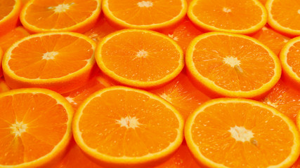 Slices of oranges as a background, top view.