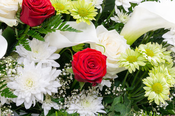 Beautiful floral background, red and white flowers closeup, Flat Lay. White and green chrysanthemum, red rose, Gypsоphila and Calla.