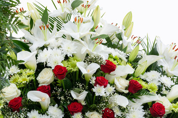 Greeting card. Red and white flowers on a white background, Copy space, place for text. White and green chrysanthemum, red rose, lily, Gypsоphila and Calla.