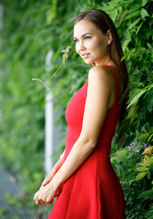 portrait of beautiful girl outdoors in red dress