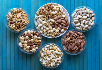 Healthy food. Nuts mix assortment on texture top view. Collection of different legumes for background image close up nuts, pistachios, almond, cashew nuts, peanut, walnut. image