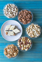  Oriental dessert halva with pistachio, almond, cashew nuts, peanut, walnut  on a  plate. Image. Healthy food. Nuts mix assortment. sweets, Turkish Delight. Isolated  background.. Eastern delicacy